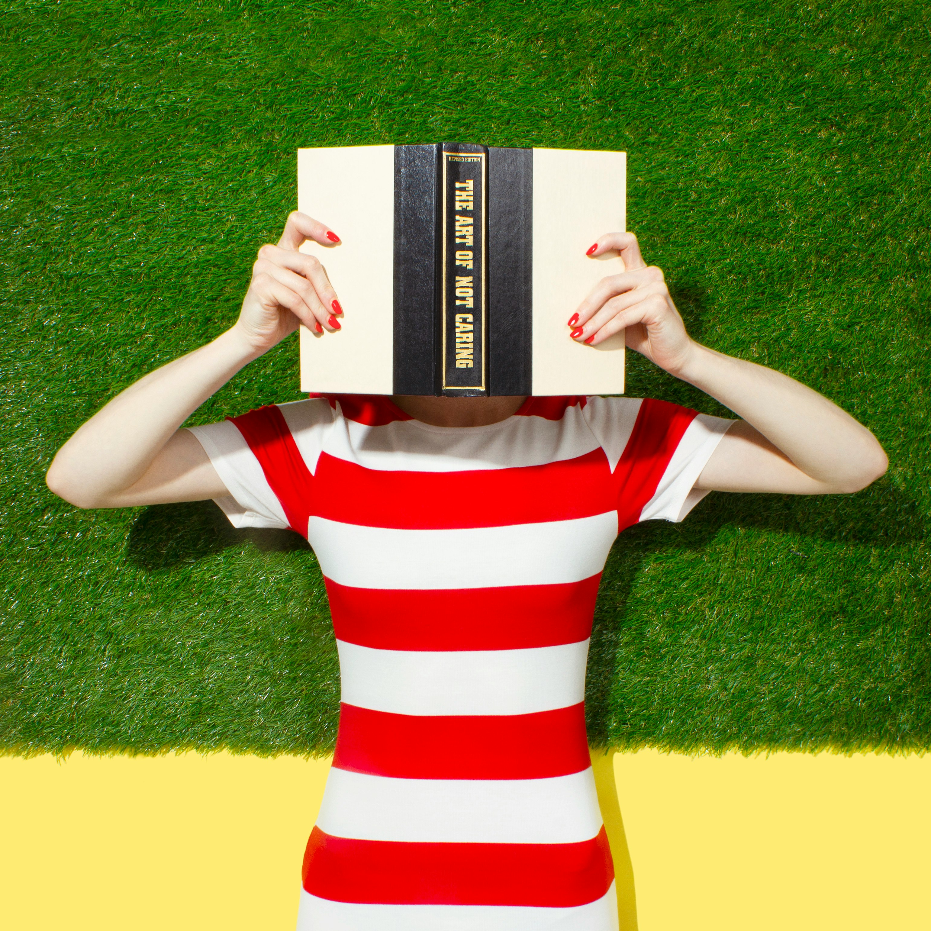 person holding black and beige book